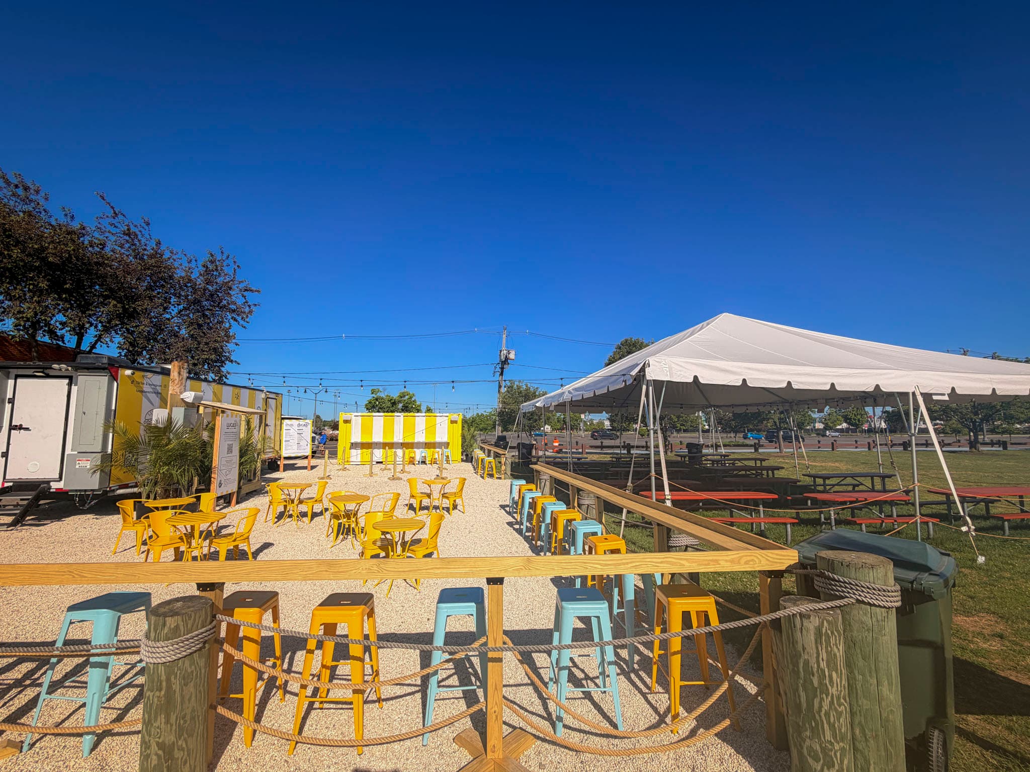 Luca's patio with yellow seating and a beach tent