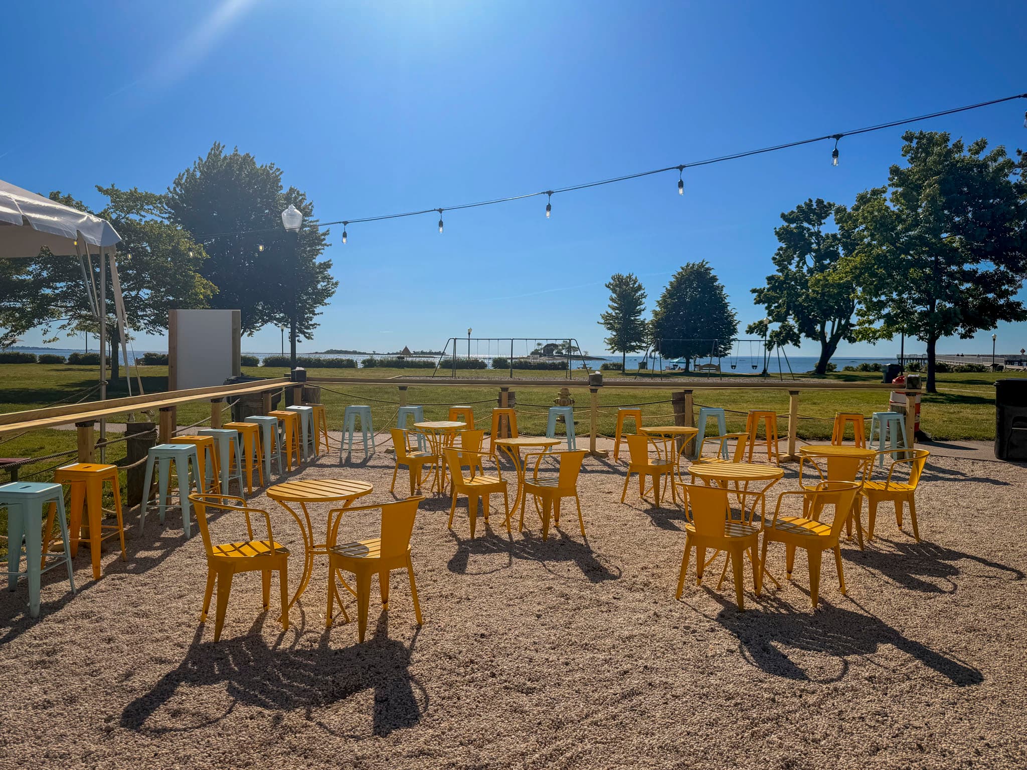 Outdoor Luca's tables facing the water at Calf Pasture Beach