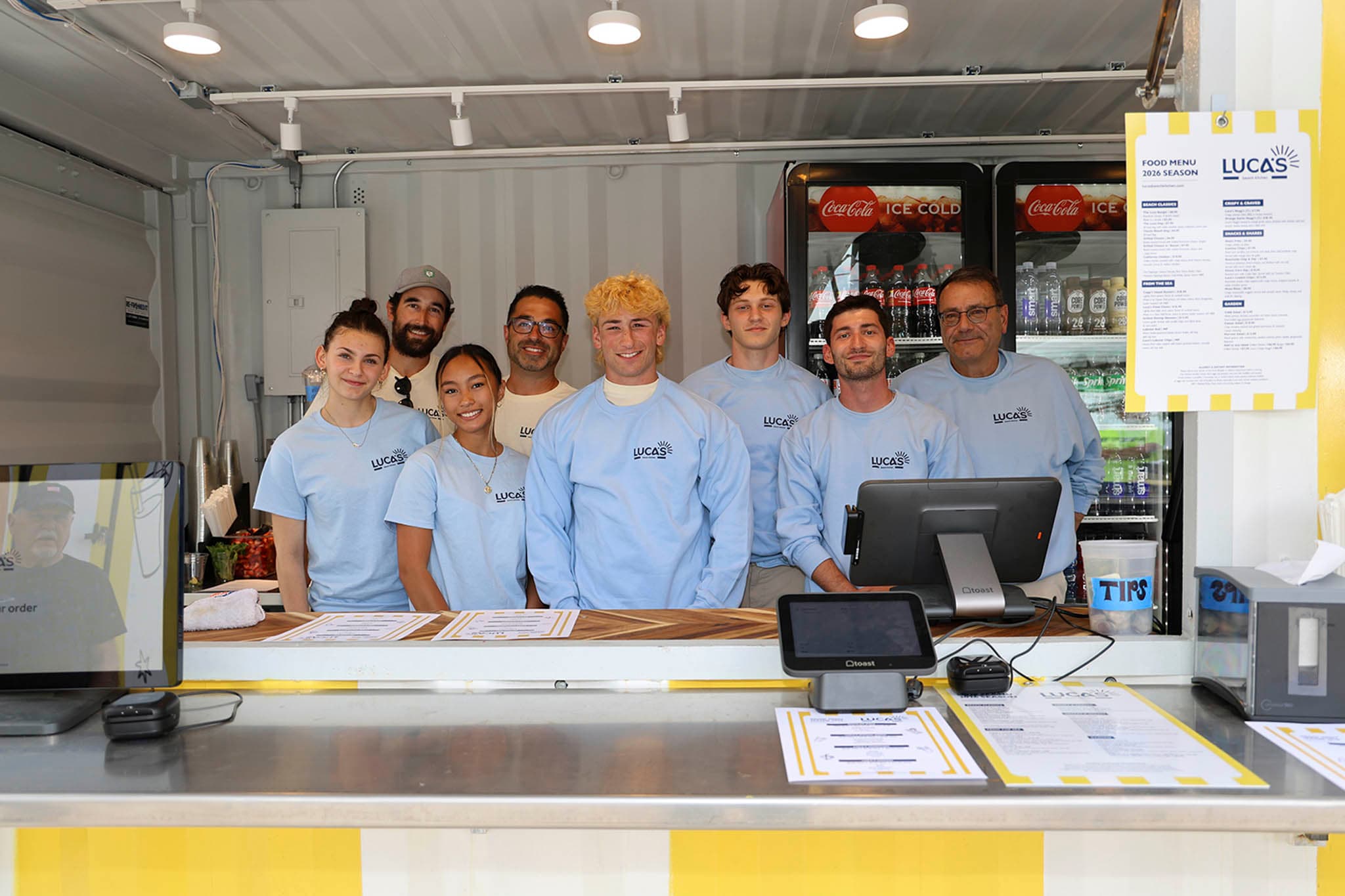 Luca's team smiling behind the counter
